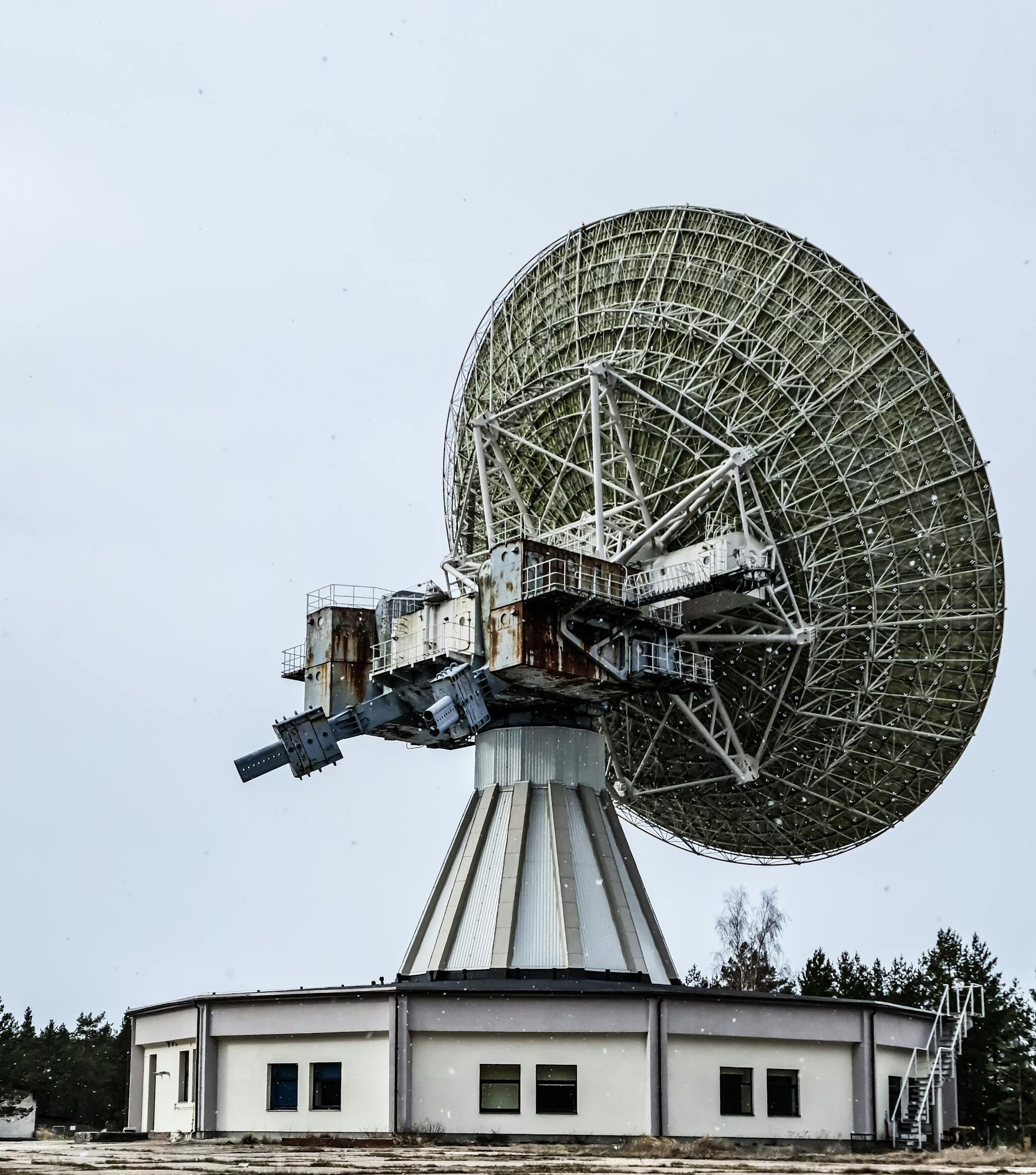 A large satellite dish used for communication and astronomy in an outdoor setting.